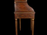 an antique writing desk with a wooden top and gold trimmings