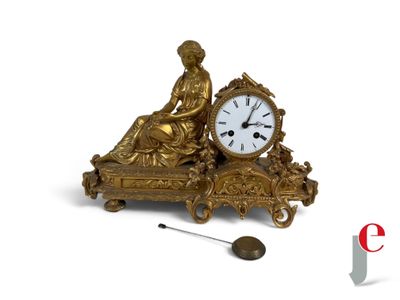 a gold clock sitting on top of a table next to a clock
