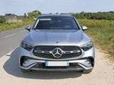 a silver mercedes suv parked on the side of the road