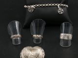 un assortiment de bijoux en argent comprenant un pendentif en forme de cœur, une bague, un bracelet et un étui à bagues