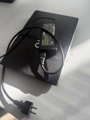 a laptop and a charger sitting on a table
