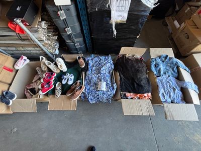 many boxes of clothes and shoes on the floor