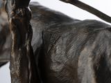 a statue of a horse with a stick on it ' s back