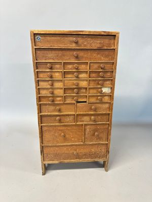 an old wooden chest of drawers with many drawers and drawers