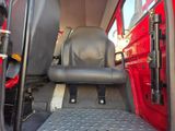 a seat in the back of a truck with the door open