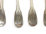four silver spoons are lined up in a row on a white surface