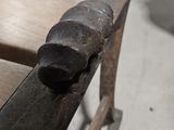 a bench with a hammer on top of it in a room