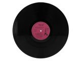 a black vinyl record with a pink label on it