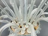 a glass vase with a bunch of white flowers inside of it