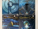 three golden city books on a white surface