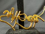 a gold brooch with a snake and a snake on it