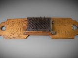 a wooden comb with a black bristles on it