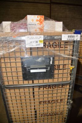 a metal cart with boxes on top of it in a warehouse