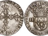 a silver coin with a cross on the front and a crown on the back