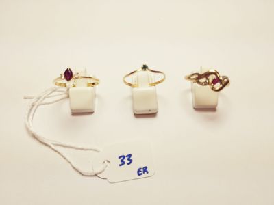 three rings and a tag on a white surface