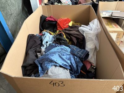 a cardboard box filled with clothes and other items