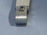 a silver metal tie bar with a heart on it