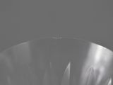 a close up of a glass bowl on a table in a dark room