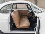 a white car with a tan leather seat in the back