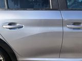 a silver car that is parked on the side of the street