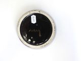 a black and white bowl with a tag on it