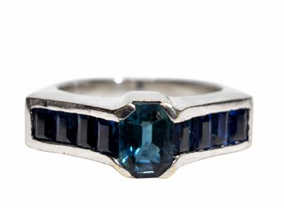 an image of a ring with a blue stone in it