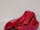 pink plastic shoe shaped toy with a black bow on the side