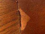 a wooden table with a piece of wood sticking out of it