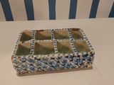 a small blue and white box on a white table