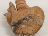 a wooden sculpture of a hand holding a piece of wood