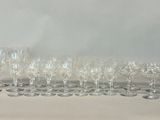 many wine glasses and a decanter on the table