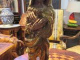 a statue of a woman holding a baby on a table