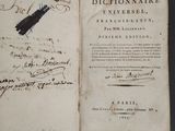 an old book with writing on it sitting on a table