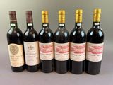 several bottles of wine are lined up on a table