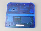 a close up of a blue nintendo game console