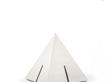a small white pyramid shaped object on a white surface