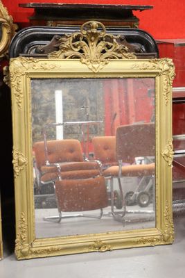 a mirror that is sitting on the floor in front of a chair