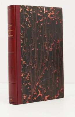a book with a red cover sitting on top of a white table