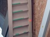a ladder leaning against a wall next to a pile of wood