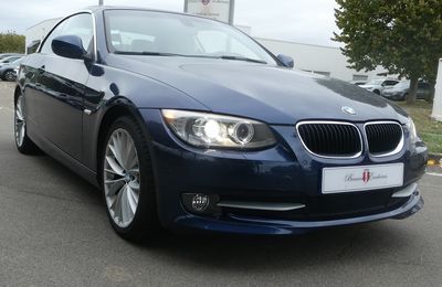 a picture of a blue bmw car parked in a parking lot