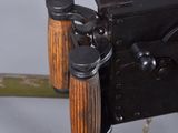 a close up of a machine gun with a wooden handle