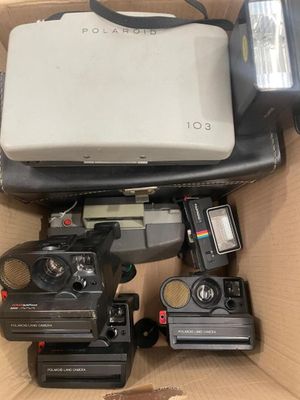a box full of cameras and a laptop in it