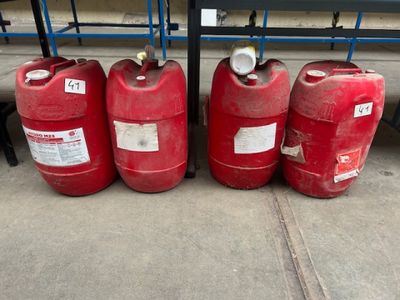 quatre bidons d'essence rouges alignés les uns à côté des autres