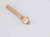 a close up of a wrist watch on a white surface