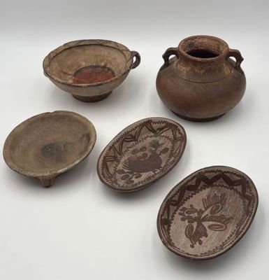 several pieces of pottery sitting on top of a table next to each other