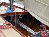 a sail boat with a rope tied to the front of it