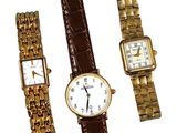 three different types of watches are displayed on a white surface