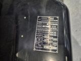 a close up of a black motorcycle with a metal panel