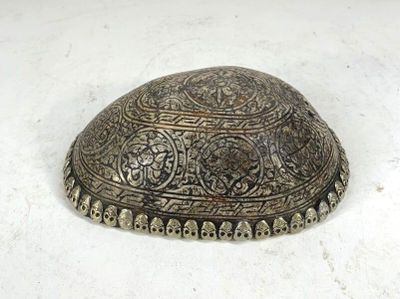a small metal object that is on a white surface