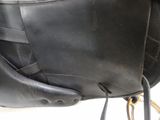 a close up of a black leather bag with a strap